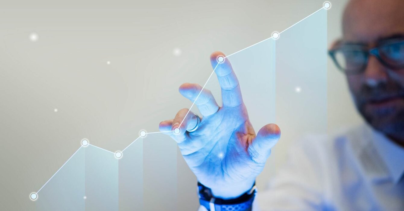 Businessman pointing his finger to a growth graph